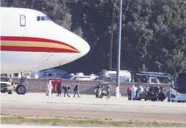  ?? RINGO H.W. CHIU AP ?? Passengers board buses at March Air Reserve Base in Riverside after arriving on an airplane carrying U.S. citizens evacuated from Wuhan, China, in January 2020.