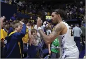  ?? GODOFREDO A. VÁSQUEZ — THE ASSOCIATED PRESS ?? Cal guard Jaylon Tyson, right, celebrates with fans after the team's victory over Oregon on Saturday in Berkeley.