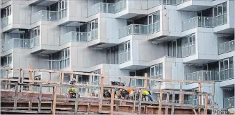  ?? DARRYL DYCK THE CANADIAN PRESS ?? Workers are seen at a condo tower under constructi­on, in Vancouver on Friday, Oct. 26, 2018.