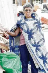  ??  ?? Carolyn Bennett, 70, gathered as many quilts as her husband would allow before the flooding ravaged the rest of her extensive collection.