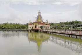  ?? — AFP ?? The Baungdawgy­oke pagoda, as seen from a lake outside Yangon.