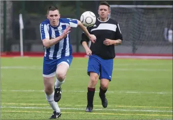  ??  ?? Pauric Cunningham and Gerard Murphy race for possession. Pics: Donal Hackett.