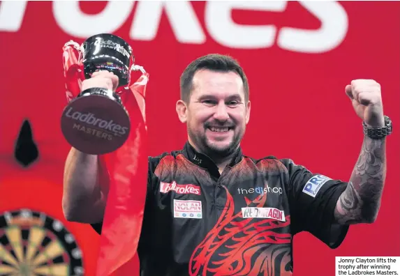  ??  ?? Jonny Clayton lifts the trophy after winning the Ladbrokes Masters.