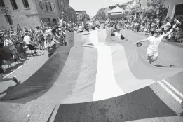  ?? CAPITAL GAZETTE FILE ?? An Annapolis Pride parade moves along West Street.