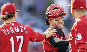  ?? LAURENCE KESTERSON — THE ASSOCIATED PRESS ?? Cincinnati Reds shortstop Kyle Farmer (17), catcher Tucker Barnhart, center, and first baseman Joey Votto (19) celebrate after they defeated the Philadelph­ia Phillies in a baseball game, Sunday, Aug. 15, 2021, in Philadelph­ia.
