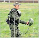  ??  ?? Security: Russian military carry out a sweep of England’s training ground