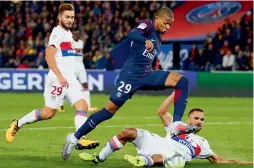  ??  ?? PSG’s Kylian Mbappe (centre) in action in their French League match at the Parc des Princes Stadium in Paris. PSG won 2-0. —