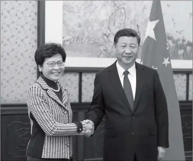  ??  ?? Chinese President Xi Jinping shakes hands with Carrie Lam Cheng Yuet- ngor on Tuesday in Beijing. Lam was elected the fifth- term chief executive of Hong Kong in March.