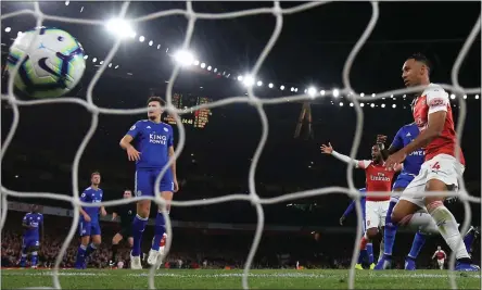  ??  ?? Pierre-Emerick Aubameyang slots home Arsenal’s third of the night after exquisite build-up from his team