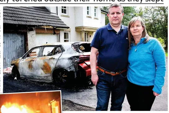  ??  ?? Shocked: Councillor Graeme Campbell and his wife Fiona were alerted to the blaze by a passer-by. Left, their BMW engulfed in flames after the attack