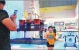  ?? WANG ZHUANGFEI / CHINA DAILY ?? A child poses in front of a model of a Chinese offshore oil drilling platform on the first day of an exhibition at the National Museum of China in Beijing on Monday. The exhibition, was launched in 2007. The current show includes the country’s latest...