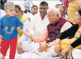  ?? HT PHOTO ?? Haryana chief minister Manohar Lal Khattar at a condolence meeting at Major Dahiya’s native village Banihari in Mahenderga­rh on Saturday. Martyr’s 2year old daughter is also seen in the picture.