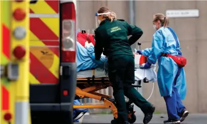  ?? Photograph: Tolga Akmen/AFP/Getty Images ?? A patient is taken from an ambulance by staff at the Royal Free hospital in London earlier this week.