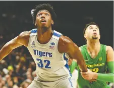  ?? STEVE DYKES/GETTY IMAGES FILES ?? James Wiseman, left, is shown playing in one of his few games as a member of the Memphis Tigers. The highly rated centre has decided to leave school in the middle of his first season, find an agent and focus on preparing for next year’s NBA draft.