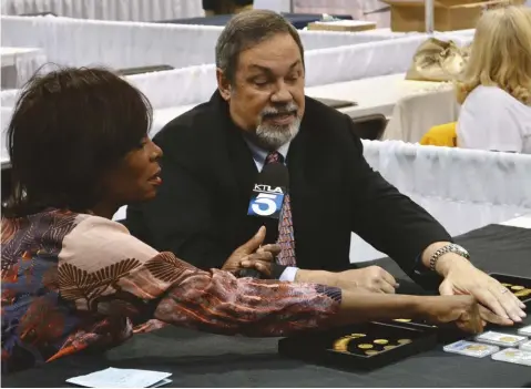  ??  ?? Mike Fuljenz showed an assortment of gold coins during an interview with KTLA-TV Los Angeles reporter Gayle Anderson at the 2016 World’s Fair of Money.