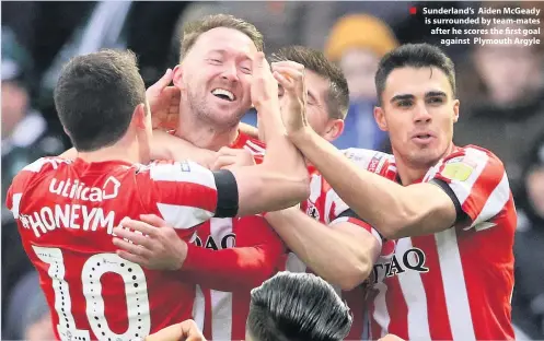  ??  ?? Sunderland’s Aiden McGeady is surrounded by team-mates after he scores the first goal against Plymouth Argyle