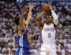  ?? (Reuters) ?? OKLAHOMA CITY THUNDER guard Russell Westbrook (right) shoots as Golden State Warriors guard Stephen Curry defends during Game 4 of the Western conference finals of the NBA Playoffs.