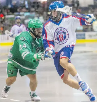  ??  ?? Victoria Shamrocks’ Derek Lloyd checks Maple Ridge Burrards’ Ryan Johnson in WLA action at The Q Centre on Friday.