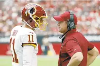  ?? RICK SCUTERI/AP ?? Quarterbac­k Alex Smith, left, has joined a group of players increasing­ly comfortabl­e with Redskins coach Jay Gruden, right.