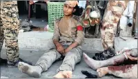  ??  ?? Syrian Democratic Forces fighters injured by a mortar round fired by IS rebels wait to be treated in a field hospital in Raqqa.
