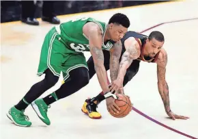  ?? DAVID RICHARD / USA TODAY SPORTS ?? Boston guard Marcus Smart (left) and Cleveland guard George Hill scramble for the ball in the second quarter.