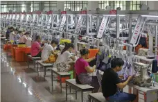  ?? AFP ?? On the production line at a swimwear manufactur­er in Jinjiang. Some factories recently began shedding jobs again