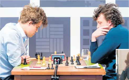  ?? Photos / Crystal Fuller, St Louis Chess Club, Netflix ?? Magnus Carlsen (left) of Norway playing Hans Moke Niemann of the US during the Sinquefiel­d Cup chess tournament in St Louis last month. Inset below, Anya Taylor-Joy as prodigy Beth Harmon in The Queen’s Gambit.