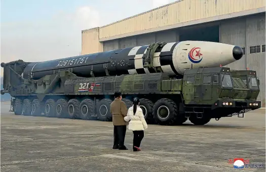  ?? AP ?? North Korean leader Kim Jong Un, left, and his daughter inspect what Pyongyang says is a Hwasong-17 interconti­nental ballistic missile at Pyongyang Internatio­nal Airport.