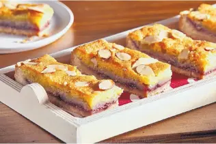  ?? TOM MCCORKLE/FOR THE WASHINGTON POST ?? The Bakewell Tart Bars recipe isn’t overly complicate­d — a buttery crust you make with your hands, topped with jam and a frangipane (almond) filling.