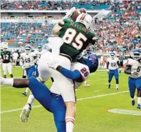  ?? MICHAEL LAUGHLIN/SUN SENTINEL ?? Miami’s Will Mallory grabs a touchdown pass in front of Savannah State’s Darrell Bonner for the first score of his career.