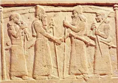  ??  ?? All done on a handshake: relief of King Shalmanese­r III of Assyria meeting a Babylonian