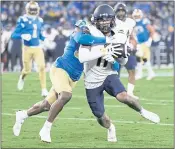  ?? JAE C. HONG — THE ASSOCIATED PRESS ?? UCLA defensive back Quentin Lake, left, stops Cal wide receiver Kekoa Crawford short of the end zone during the first half Saturday in Pasadena.