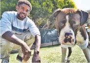  ?? AP PHOTO/RICHARD VOGEL ?? Ro Mantooth plays with his dog, Champ, at a dog park operated by the nonprofit People Assisting the Homeless, in the Venice section of Los Angeles on April 5. It was the first facility of its kind in Los Angeles County to allow homeless shelter residents to bring animal companions.