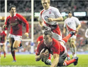  ??  ?? Lee Byrne outpaces Jonny Wilkinson to score a try during the RBS Six Nations Championsh­ip match between England and Wales in February 2008