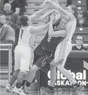  ?? DEREK MORTENSEN/The StarPhoeni­x ?? Taya Keujer fights for the ball after a high pass near the sideline as the University of Saskatchew­an Huskies take on the University of Calgary Dinos in CIS action on Saturday. The Huskies defeated the Dinos 72-68.