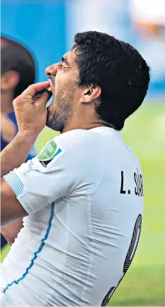  ??  ?? Painful day: Luis Suarez bit Italy’s Giorgio Chiellini in 2014