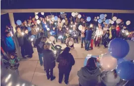  ?? EDDIE MOORE/JOURNAL ?? Helium-filled balloons were part of a vigil held Wednesday night in Nambé for Jeremiah Valencia, 13, who was killed at a home not far from where the vigil took place.