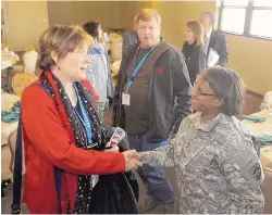  ?? GREG SORBER/JOURNAL ?? Maj. Gen. Gwen Bingham, right, greets E. DeAnn Eaton of Albuquerqu­e, CEO of Haverland Carter Lifestyle Group, during a Leadership New Mexico luncheon at White Sands Missile Range in January 2014.
