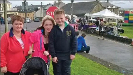  ??  ?? Patsy Fitzpatric­k,Ballyduff with daughter Nicole and grandsons Keegan and baby Clayton at the Ballyheigu­e Pattern last Friday. Photo Moss Joe Browne