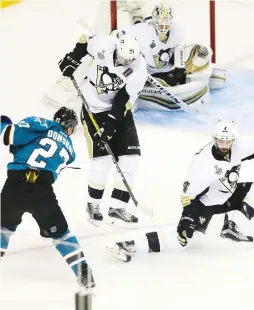  ??  ?? SAN JOSE SHARKS forward Joonas Donskoi (27) takes the game-winning shot past Pittsburgh Penguins players Evgeni Malkin, Justin Schultz and goalie Matt Murray to give the Sharks a 3-2 overtime home victory on Saturday night. The Penguins still lead the...