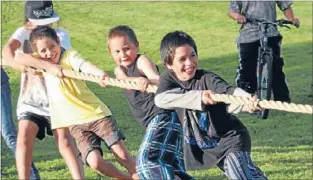  ??  ?? PULL: Children at the Papanui Reserve neighbourh­ood party work hard to win a game of tug-of-war.