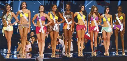  ?? AP ?? Miss Universe contestant­s pose at the Mall of Asia Arena after making it to the Top 9 yesterday. From left: Maxine Medina of the Philippine­s, Raquel Pellisier of Haiti, Sierra Bearchell of Canada, Andrea Tovar of Colombia, Mary Were of Kenya, Kristal...