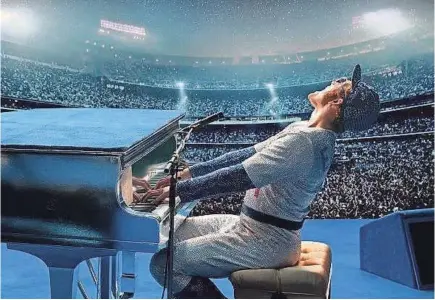  ??  ?? Taron Egerton is Elton John in “Rocketman.” “Don’t copy me, do it your way,” John told Egerton.