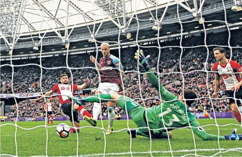  ??  ?? Safe and sound: Marko Arnautovic helps West Ham to victory with the first of two goals as stewards (left) watch for trouble that never arose