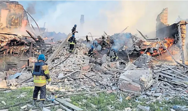  ?? ?? DEVASTATIO­N: Firefighte­rs tackle a blaze amid the rubble of the flattened school in the village of Bilohorivk­a, Luhansk, Ukraine, yesterday.