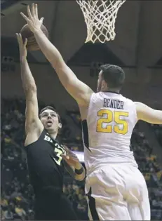  ?? Ray Thompson/Associated Press ?? Baylor guard Jake Lindsey (3) drives to the basket against West Virginia forward Maciej Bender Tuesday night.