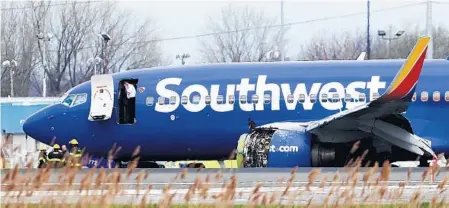  ?? DAVID MAIALETTI/THE PHILADELPH­IA INQUIRER ?? A Southwest Airlines plane sits on the runway at the Philadelph­ia Internatio­nal Airport after it made an emergency landing Tuesday in Philadelph­ia.