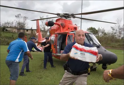  ?? The Associated Press ?? A coast guard helicopter arrives to deliver emergency supplies after the passing of of Hurricane Maria, in Utuado, Puerto Rico, on Saturday. San Juan Mayor Carmen Yulin Cruz on Friday accused the Trump administra­tion of “killing us with the...