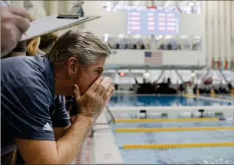  ?? LIBBY O’NEILL — BOSTON HERALD ?? Haverhill’s assistant coach George Nigro cheers during the boys 400 yard freestyle relay during the Division 1 State Boys Swimming and Diving tournament at MIT Recreation Zesiger Sports and Fitness Center.