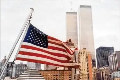  ?? PHOTO BY HAROLD MORDT ?? In 2000, one year before the 9/11 attacks, the World Trade Center towers stand tall above Manhattan. Most of the 2,977 people killed in the terrorist attacks on New York and Washington, D.C., were in one of the towers or in the surroundin­g area.